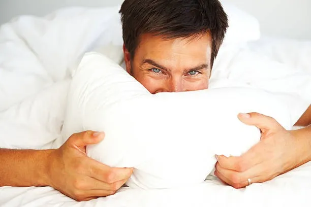 young-man-lying-on-bed-with-face